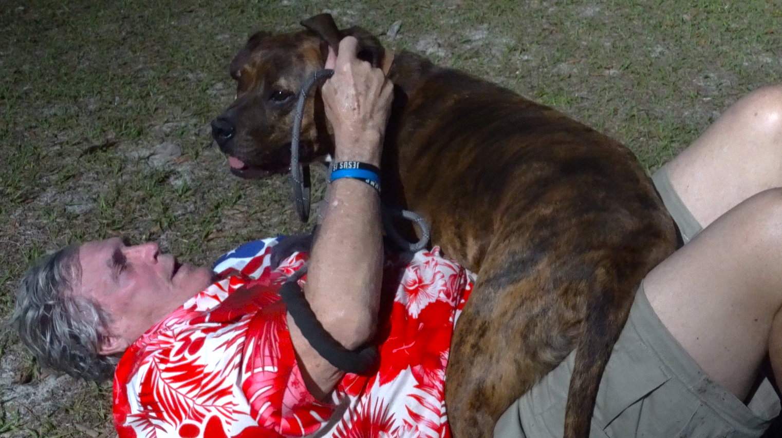 Man on the ground with dog.