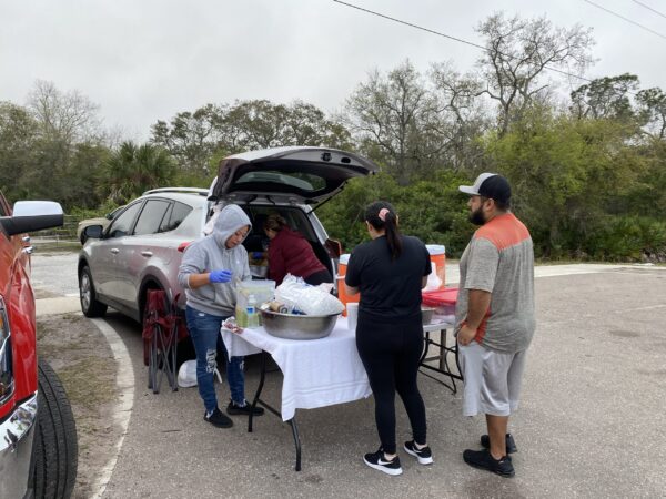 People line up to purchase a roadside Mexican meal, including tamales & gorditas.