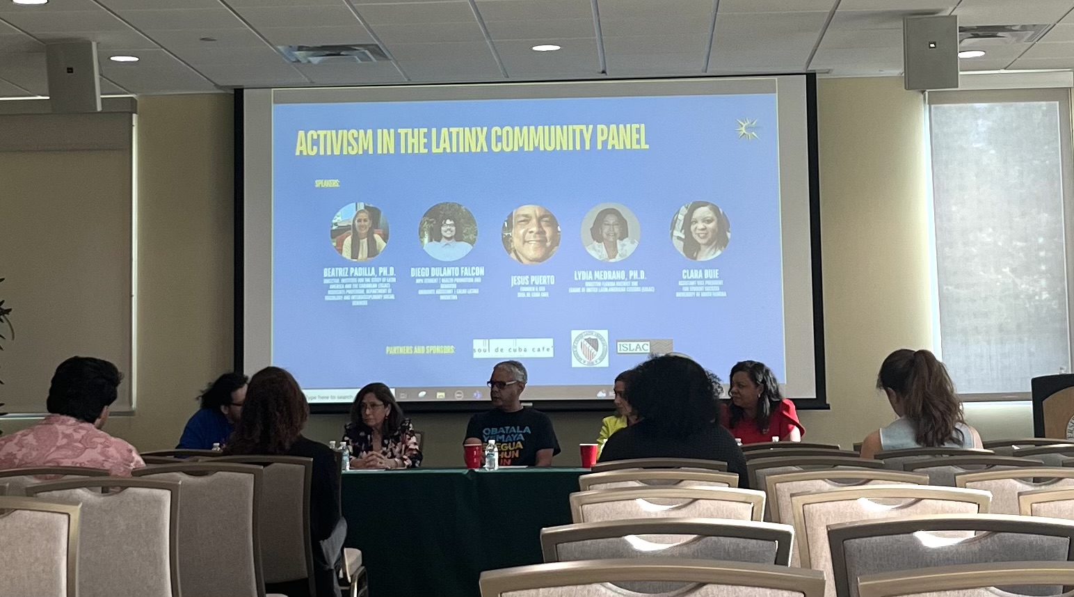 The five panelists are sitting at the table.