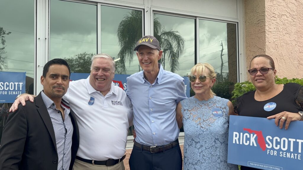 Senator Rick Scott poses for a picture with his wife and supporters during a rally in Tampa.