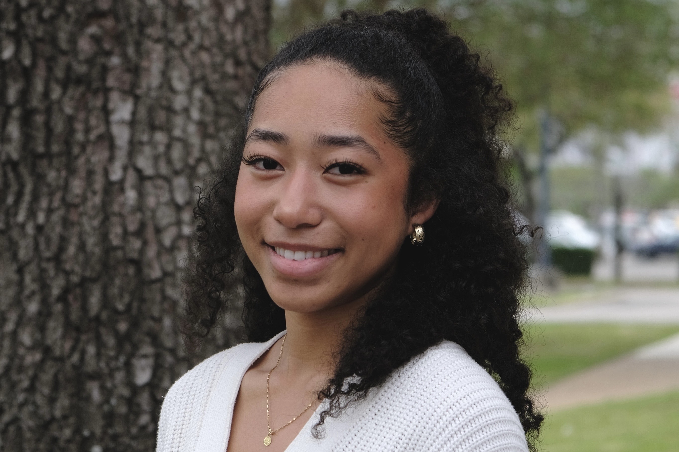 This is a photo of Tiffany Colston, a student at the University of Houston, posing in front of a tree. Image by Tiffany Colston