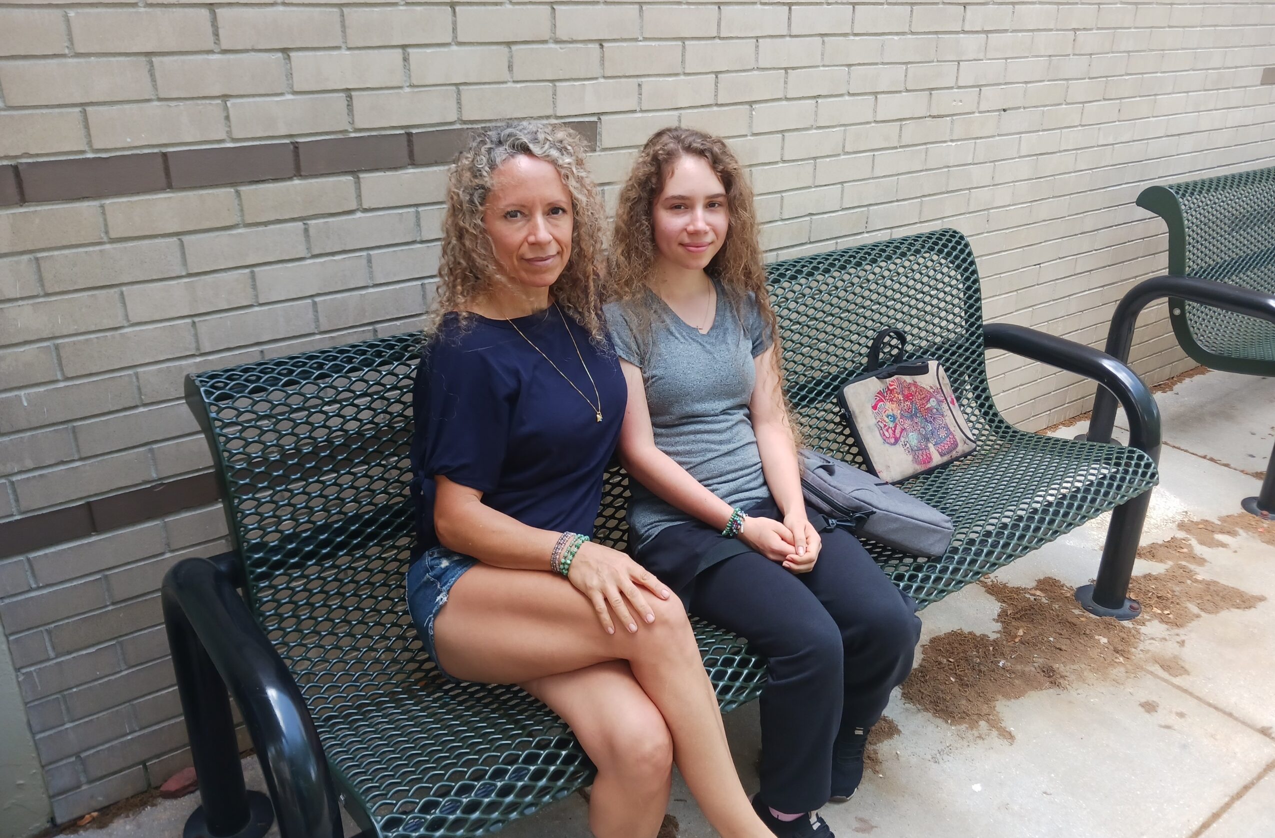 This is a picture of Baylee and Lupe Aguilar sitting down on a bench at campus. Image by Sakthivel Sabapathy