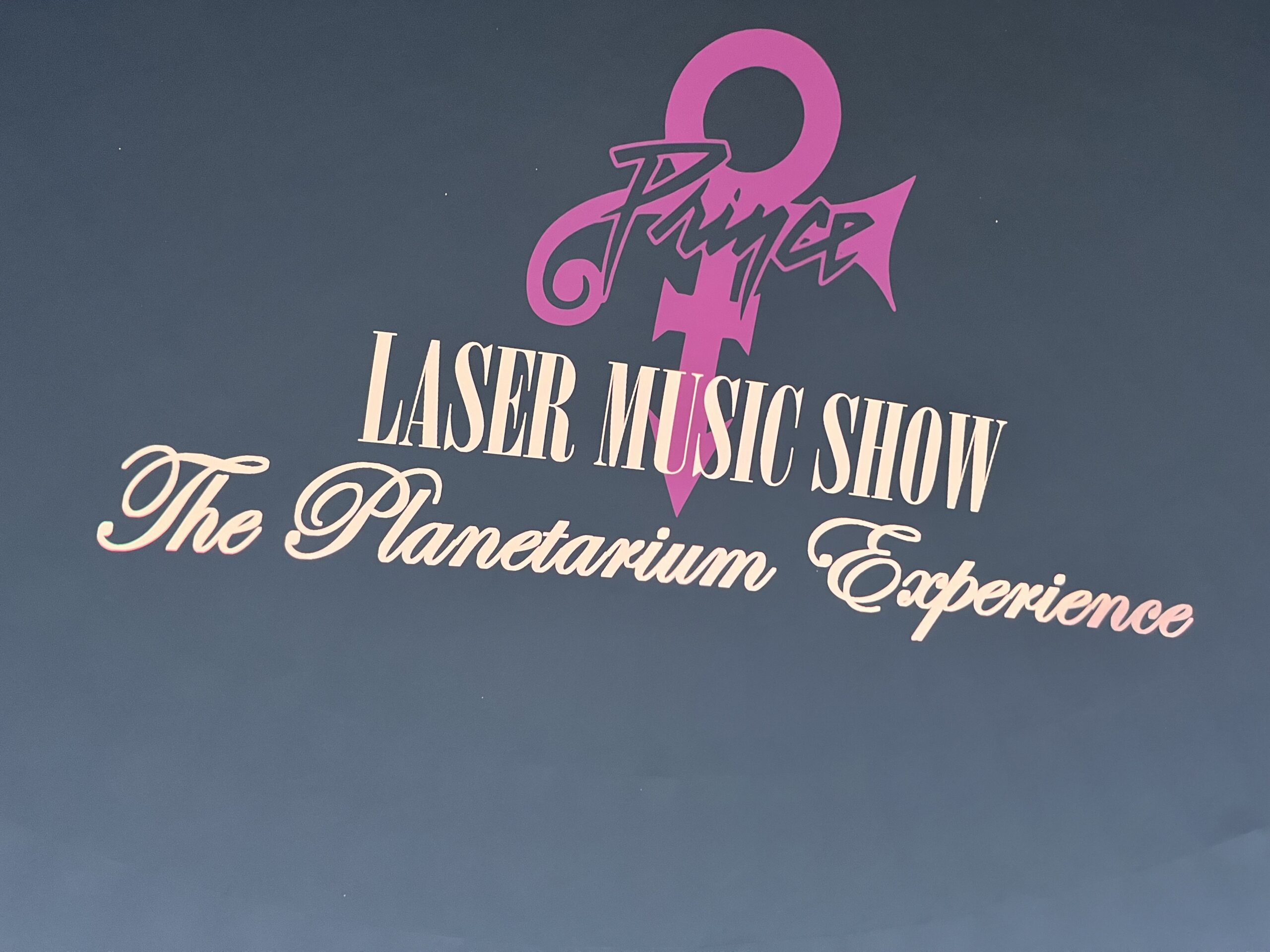 The Prince logo and Planetarium Experience os presented to guests as they enter the MOSI Planetarium. The greetings sits above the heads of guests as they find their seats.