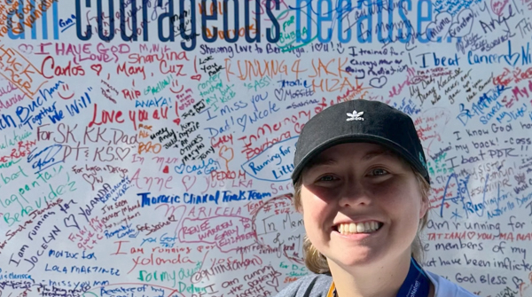 Alexis Buchman stands in front of a whiteboard