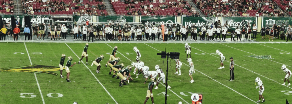 The Bulls and the Charlotte 49ers line up for a play during their football game. 