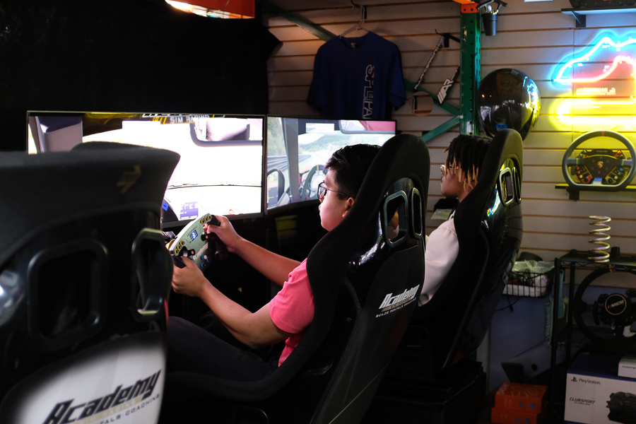 Students race on a driving simulator as part of the USF Racing Club