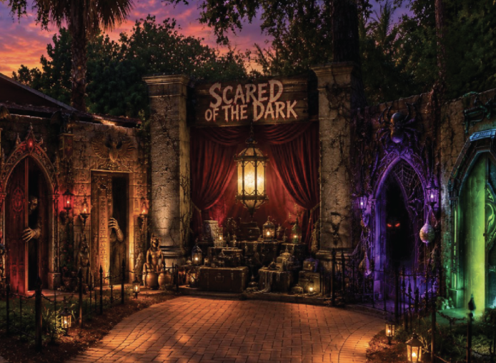 This is a photo of the entrance to "scared of the dark" at ZooTampa, it shows a scary entrance with red curtains